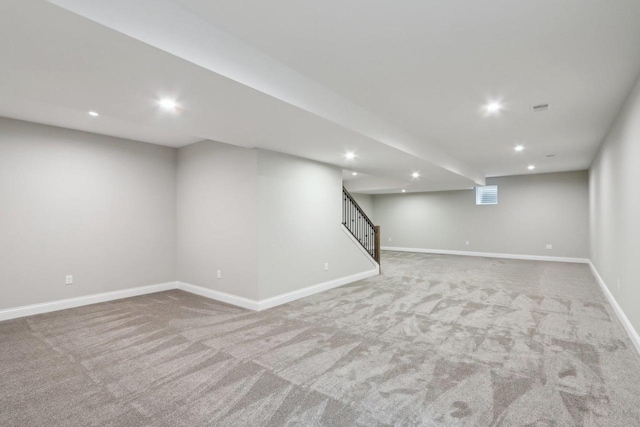 finished basement featuring recessed lighting, stairway, and baseboards