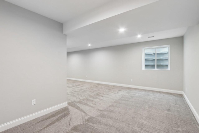 carpeted spare room featuring recessed lighting, visible vents, and baseboards