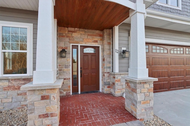 property entrance with stone siding and a porch