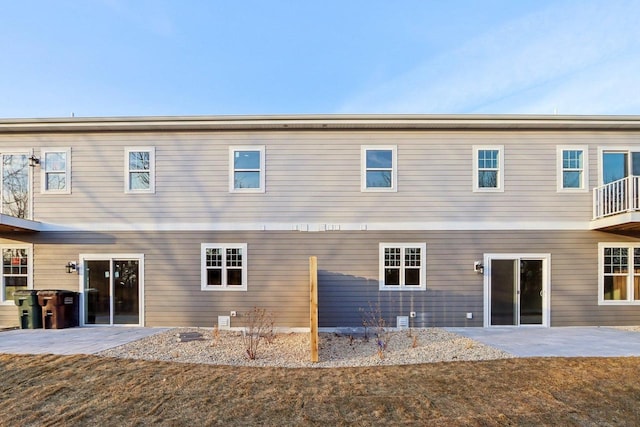 back of property with a patio area and a yard