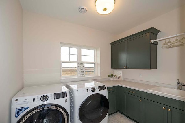 washroom featuring sink, cabinets, and independent washer and dryer