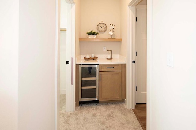 bar featuring light carpet and wine cooler