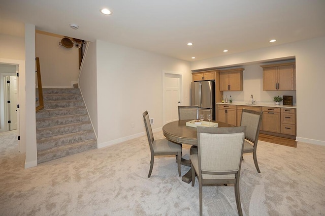 dining room featuring light colored carpet and sink