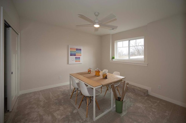 carpeted dining room featuring ceiling fan