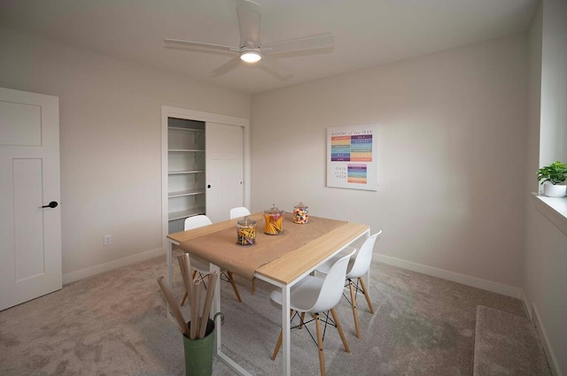 dining space with ceiling fan and carpet floors