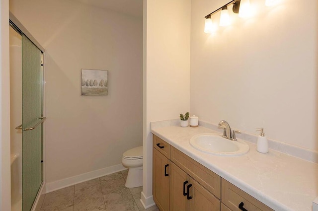 bathroom featuring vanity, an enclosed shower, and toilet