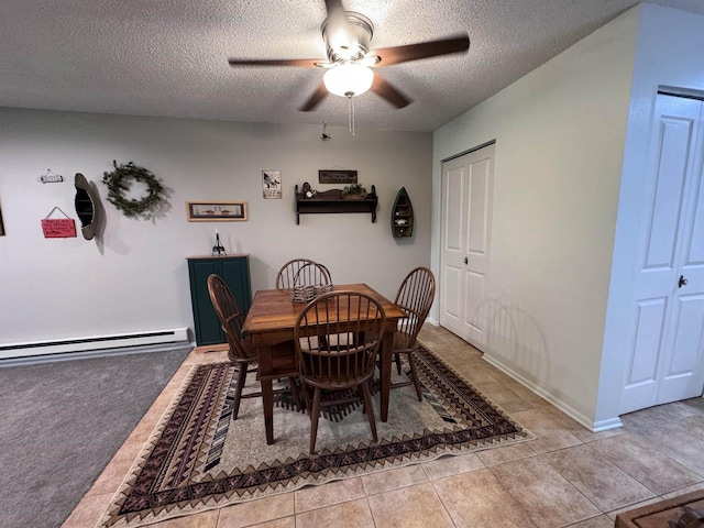 dining room featuring light tile patterned floors, a textured ceiling, a baseboard radiator, and ceiling fan