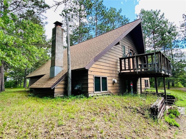 rear view of house featuring a wooden deck