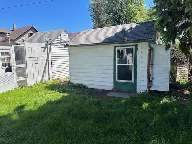 view of outbuilding featuring a lawn