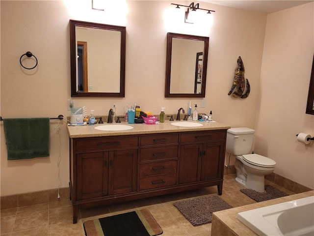 bathroom with toilet, vanity, and tile patterned floors