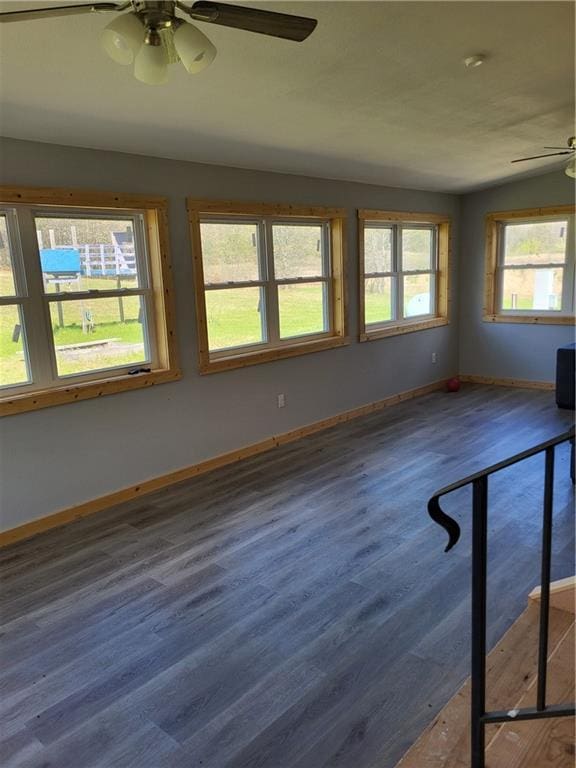 spare room with hardwood / wood-style flooring, ceiling fan, a wealth of natural light, and vaulted ceiling