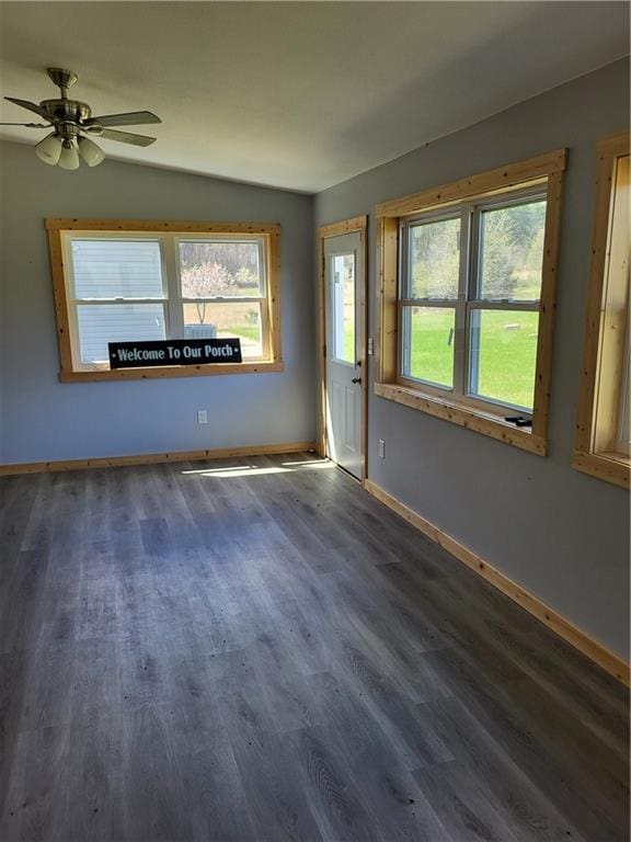 spare room with dark hardwood / wood-style floors, ceiling fan, and lofted ceiling