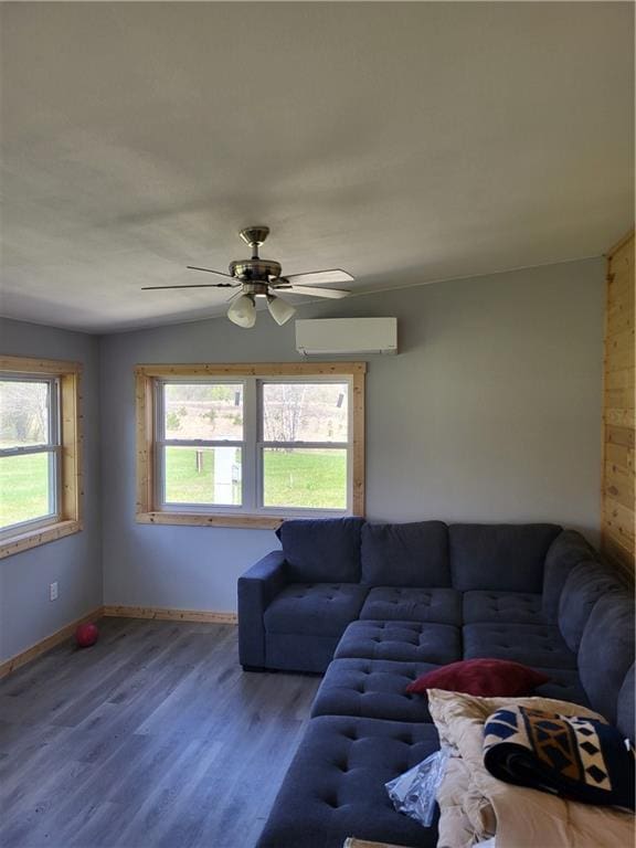 living room with hardwood / wood-style flooring, a healthy amount of sunlight, lofted ceiling, and a wall mounted AC