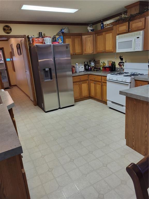 kitchen featuring white appliances and crown molding