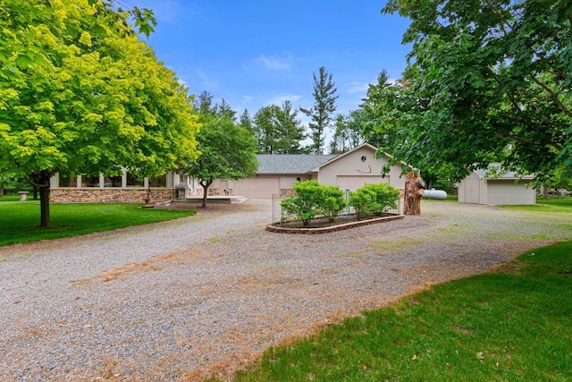 view of front of property with a garage and a front yard