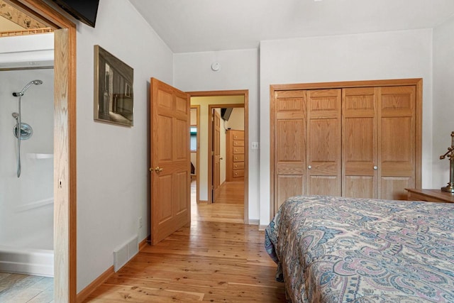 bedroom featuring light wood-type flooring and a closet