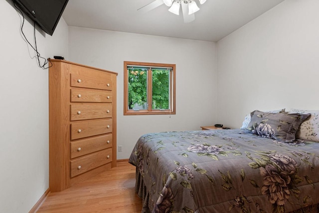 bedroom with ceiling fan and light hardwood / wood-style flooring