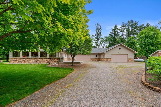 view of front of property with a garage and a front lawn