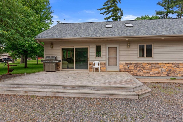 rear view of house featuring a deck