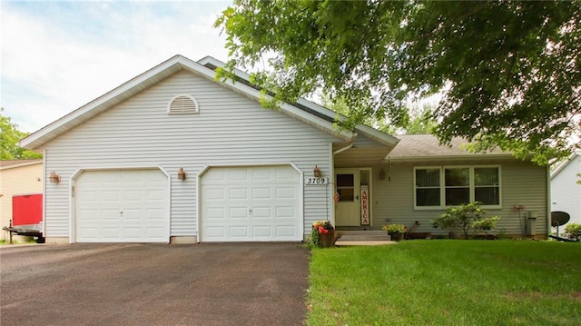 ranch-style home with a front yard and a garage