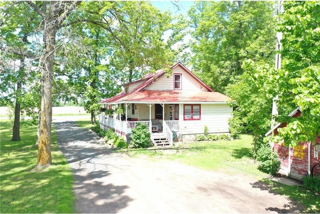 view of front of house featuring covered porch and a front yard