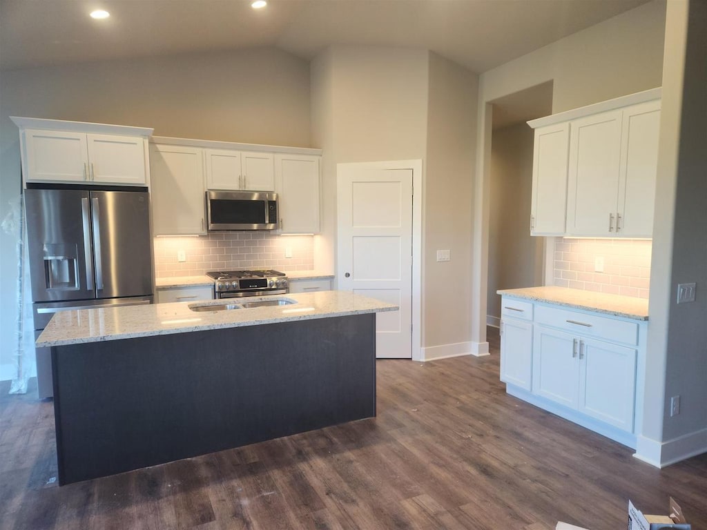 kitchen featuring a kitchen island with sink, dark wood-type flooring, white cabinets, and stainless steel appliances