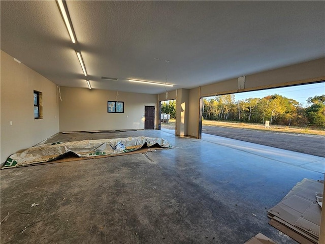 unfurnished living room with concrete floors and a textured ceiling