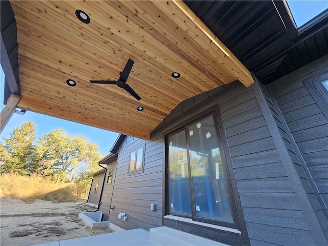 view of side of home featuring entry steps and a ceiling fan