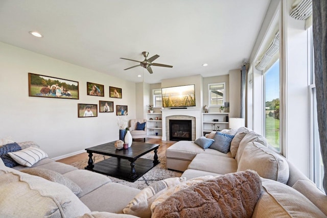 living room with wood-type flooring and ceiling fan