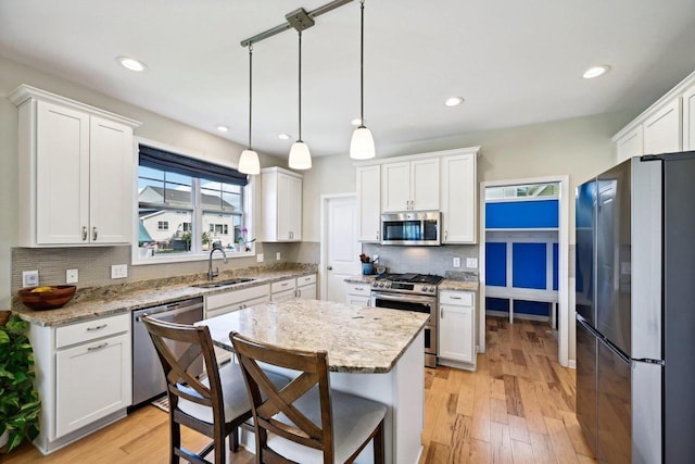 kitchen featuring white cabinetry, light hardwood / wood-style flooring, and appliances with stainless steel finishes