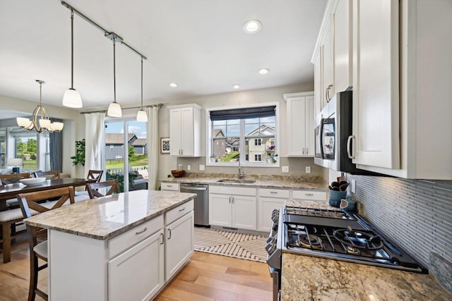 kitchen featuring stainless steel appliances, white cabinetry, and a healthy amount of sunlight