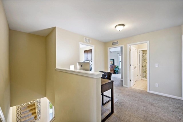 corridor with light colored carpet