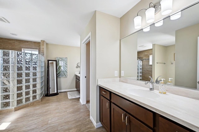 bathroom featuring vanity, curtained shower, and wood-type flooring