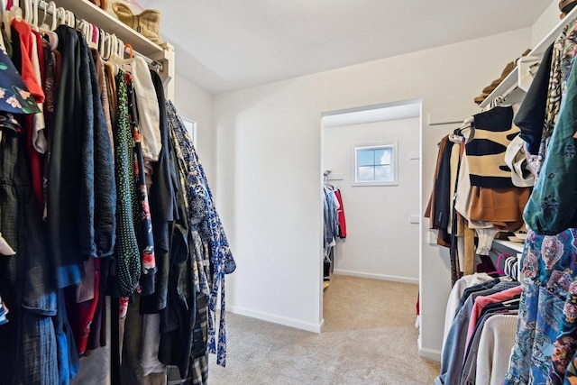 spacious closet with light colored carpet