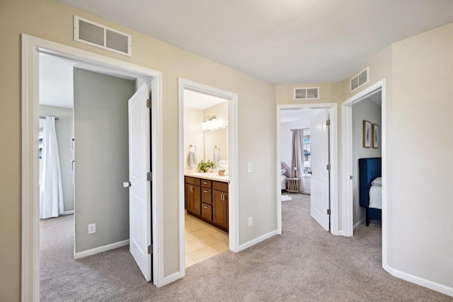 hallway featuring light carpet