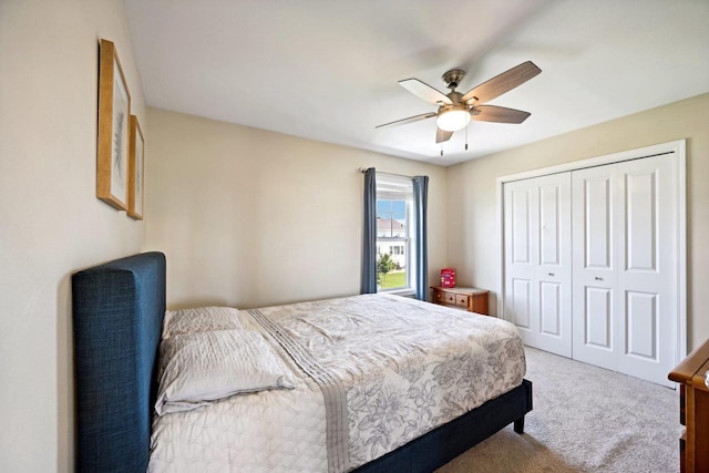 bedroom featuring ceiling fan, a closet, and carpet