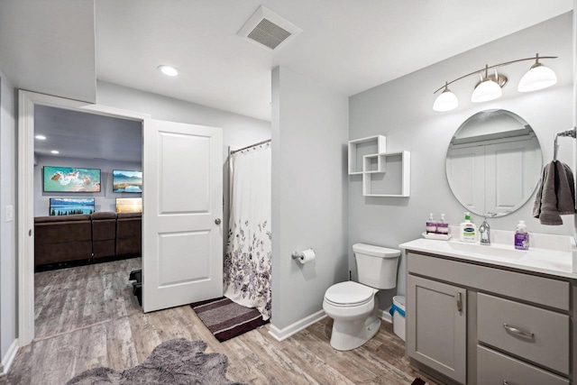 bathroom featuring vanity, toilet, and wood-type flooring