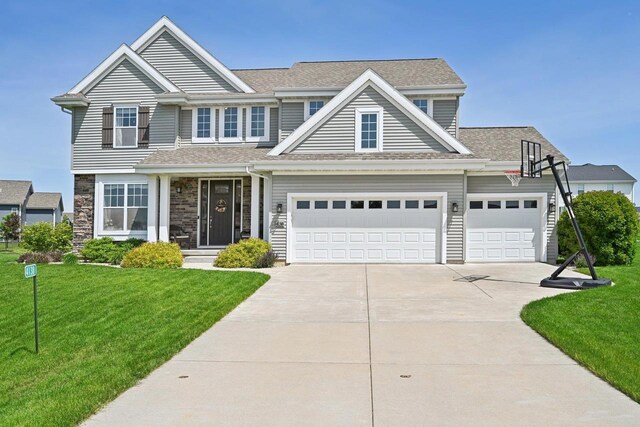 view of front of home with a front lawn and a garage