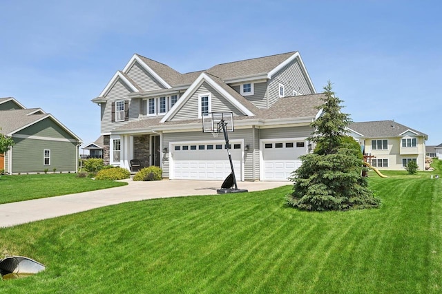 view of front of property with a garage and a front lawn