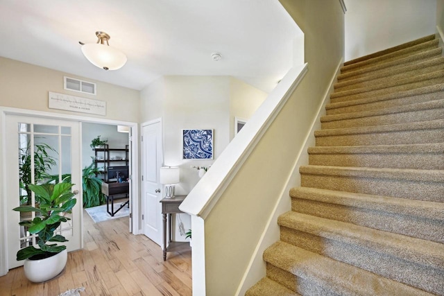 stairway with hardwood / wood-style flooring