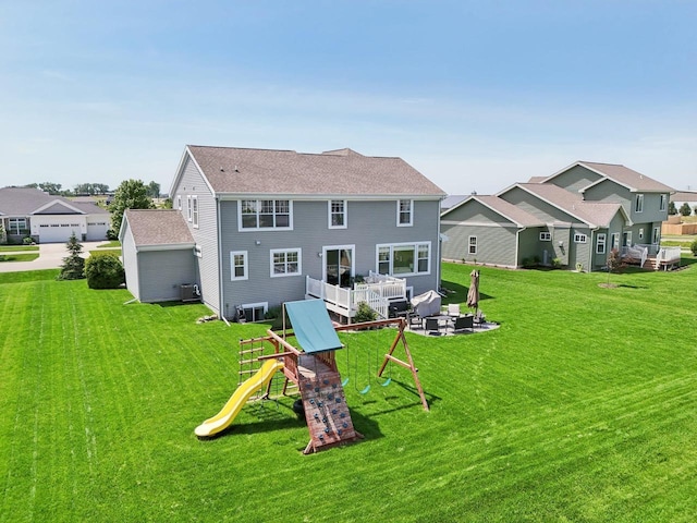 rear view of house featuring a playground and a lawn