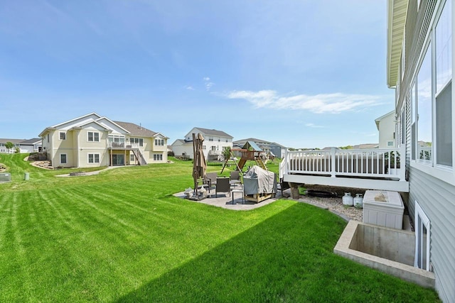 view of yard featuring a patio and a wooden deck