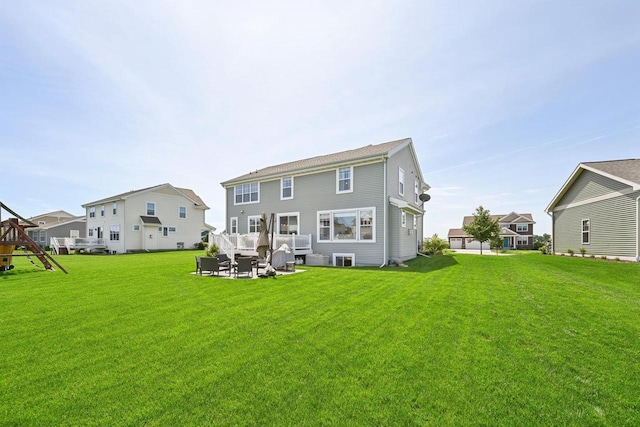 back of house with outdoor lounge area and a yard