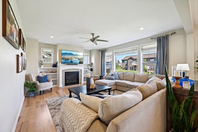 living room featuring light hardwood / wood-style flooring and ceiling fan