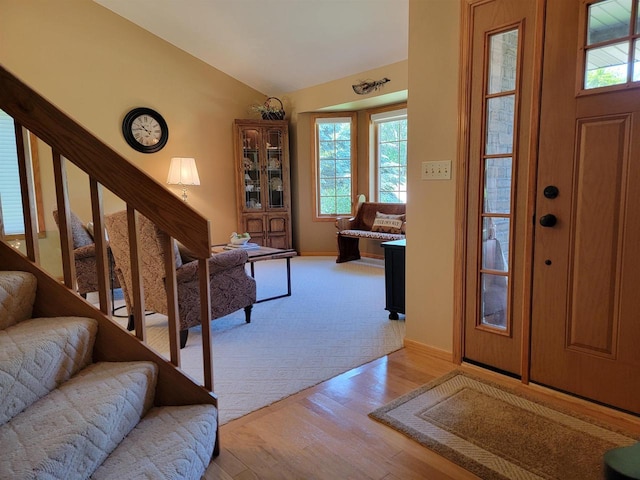 foyer entrance featuring light hardwood / wood-style floors and vaulted ceiling