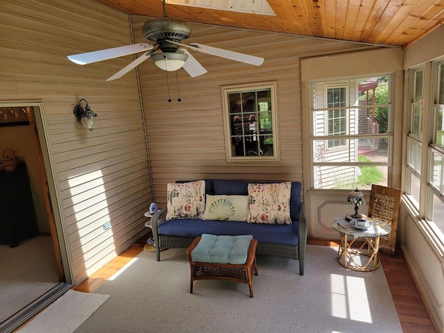 sunroom / solarium featuring vaulted ceiling, ceiling fan, and wood ceiling