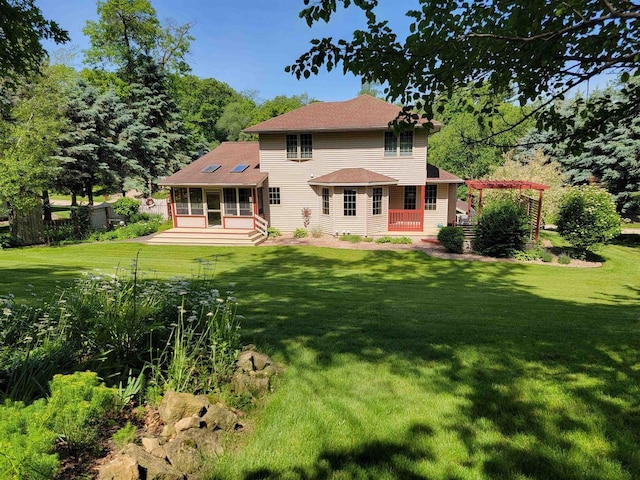 back of house with a pergola, a yard, and a patio