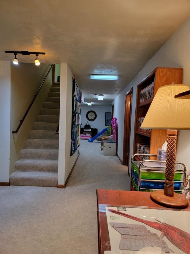 interior space with carpet floors and track lighting