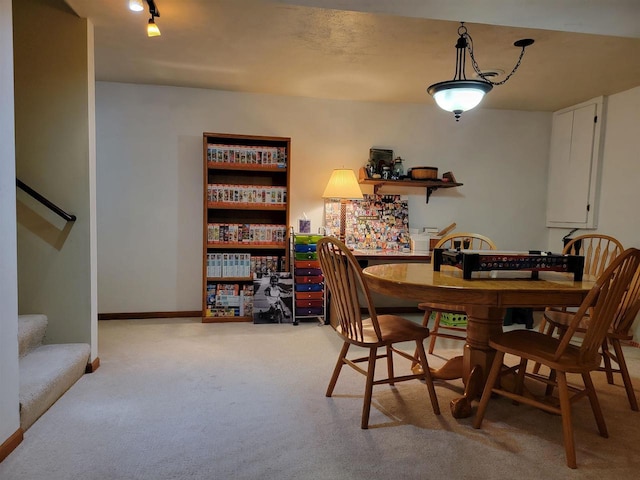 dining space featuring light colored carpet