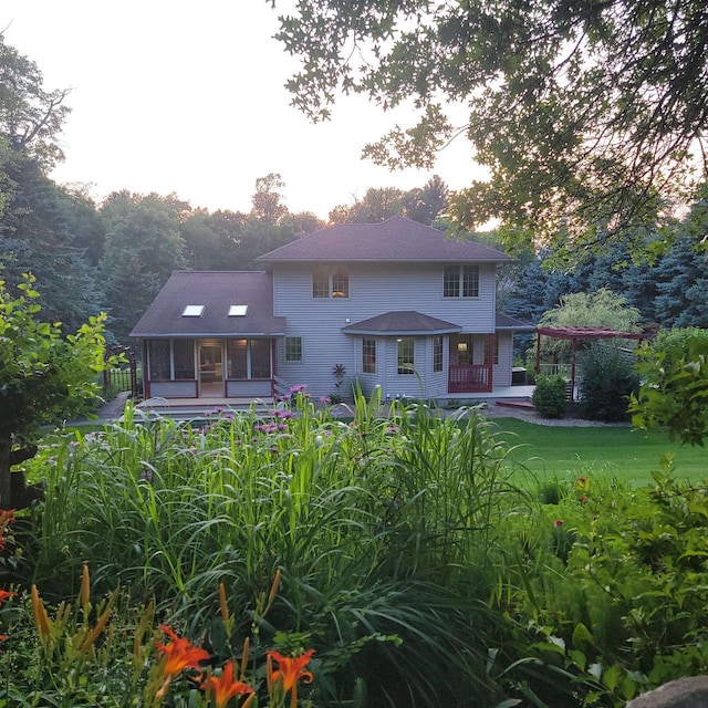 back of property with a lawn